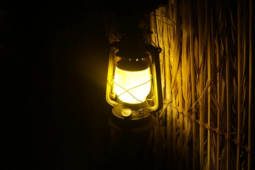 Lantern glowing at the desert camp after dark