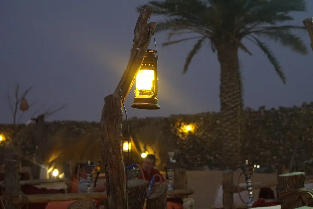 Desert camp lit by lanterns for the premium BBQ dinner